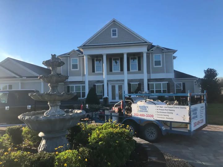 Colonial house with fountain and landscaping truck